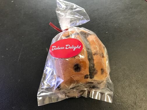 Hot cross buns delivered to tenants of Springetts Arcade by Bakers Delight